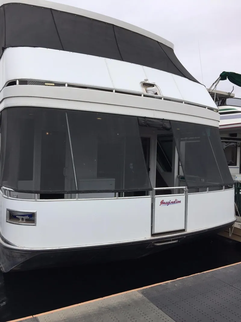 Slide: The Image of Luxury Bravada houseboat, 2014 model, docked with sleek design and modern features. - 2