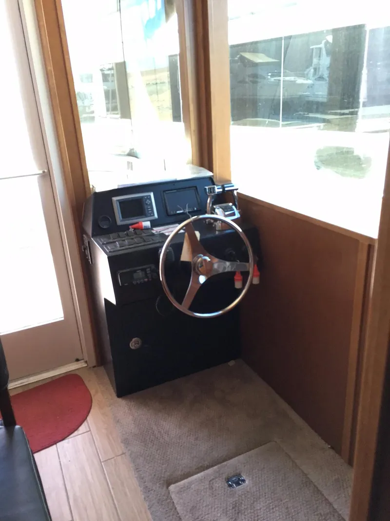 Slide: The Image of Steering area of 2014 Bravada Imagination Share #4 houseboat with control panel and wheel. - 24