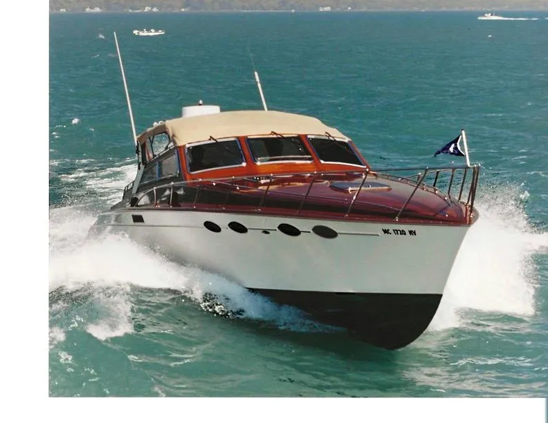 Slide: The Image of 1990 Mays Craft 44 yacht cruising on open water, showcasing sleek design and powerful performance. - 1