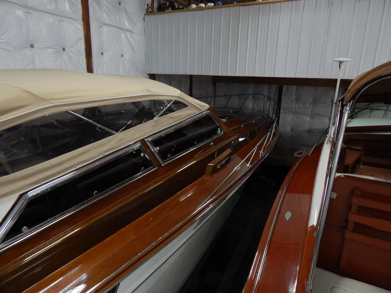 Slide: The Image of 1990 Mays Craft 44 boat with wooden finish in storage. - 15