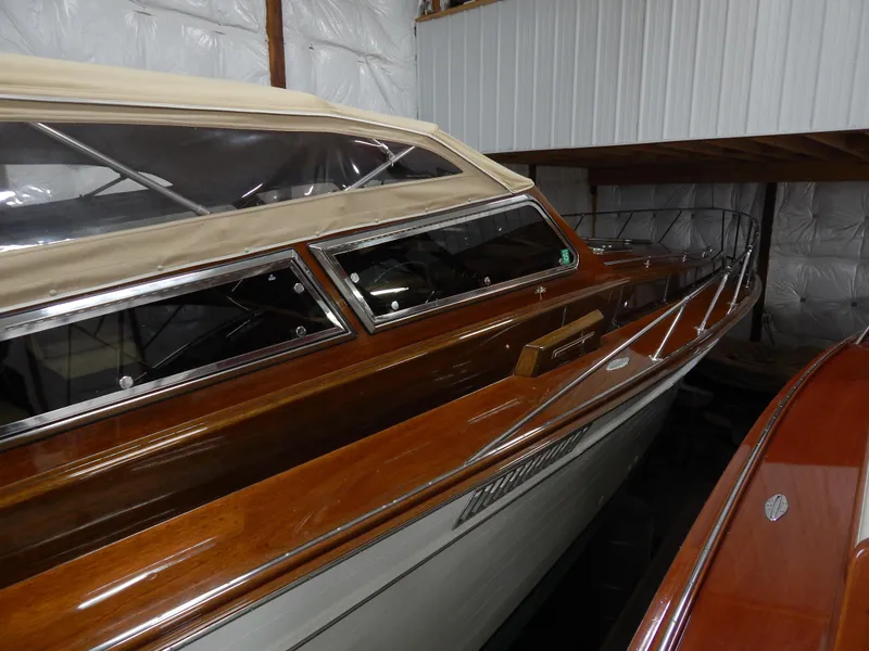 Slide: The Image of 1990 Mays Craft 44 boat with wooden finish, stored indoors. - 16