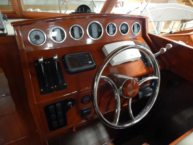 Slide: The Image of Helm of 1990 Mays Craft 44 boat with wooden dashboard and chrome steering wheel. - 19