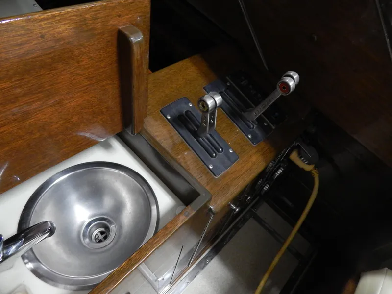 Slide: The Image of Interior of 1990 Mays Craft 44 boat with sink and control levers. - 22