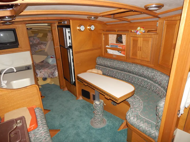 Slide: The Image of Interior of 1990 Mays Craft 44 boat with cozy seating and wooden cabinetry. - 23