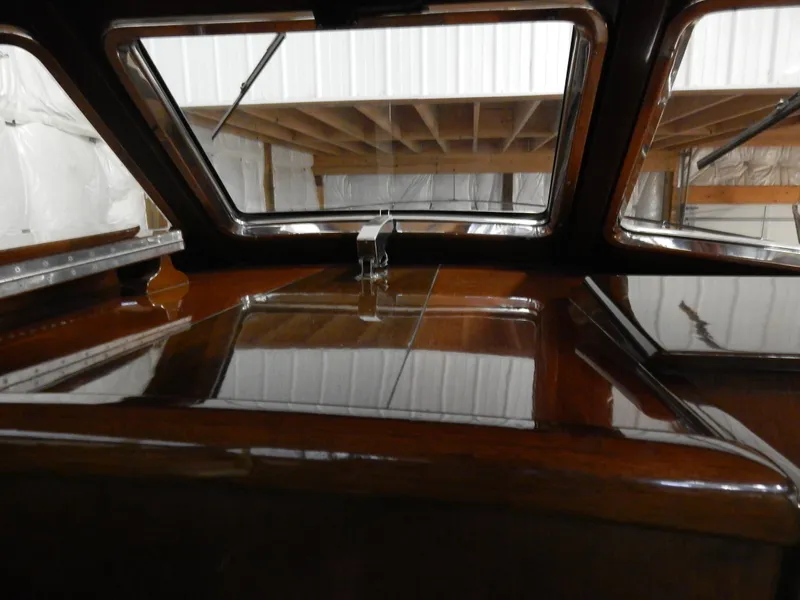 Slide: The Image of Interior view of a 1990 Mays Craft 44 boat with polished wood finish. - 27
