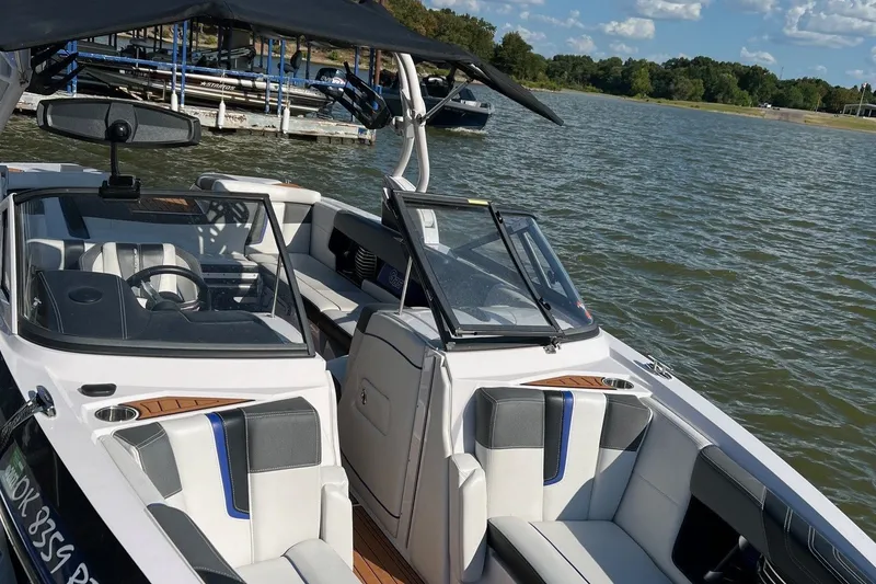 Slide: The Image of A 2015 Nautique Super Air Nautique G25 with open cockpit and luxurious seating on a lake. - 8