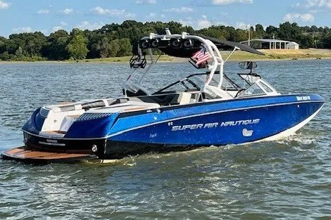 Slide: The Image of A blue boat on a lake, featuring a tower and an American flag. - 11