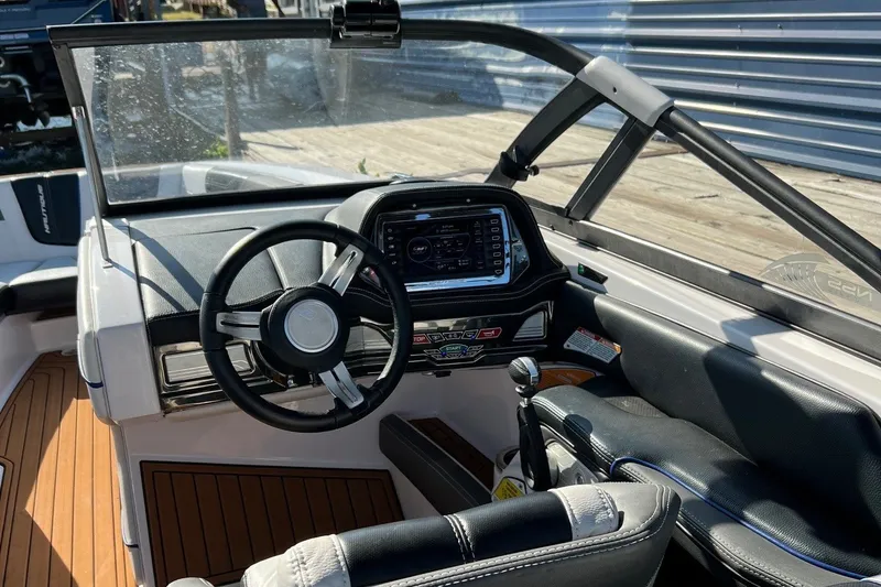 Slide: The Image of The image shows the cockpit of a 2015 Nautique Super Air Nautique G25 with a modern helm. - 7