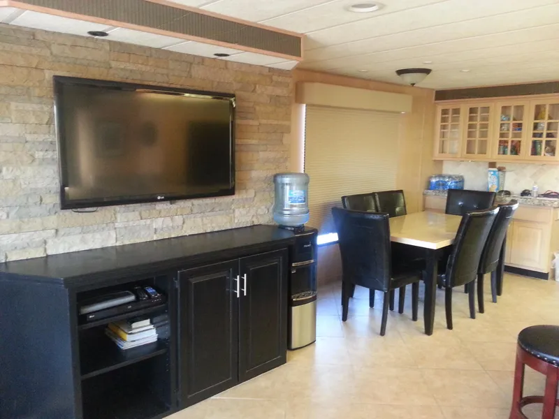 Slide: The Image of Interior of 2001 Stardust Cruisers Desert Oasis Share 20 with TV, dining area, and cabinets. - 3