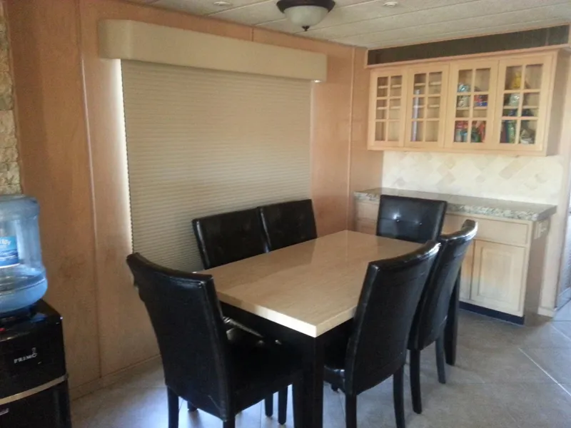 Slide: The Image of Dining area in 2001 Stardust Cruisers Desert Oasis Share 20 with table and leather chairs. - 6