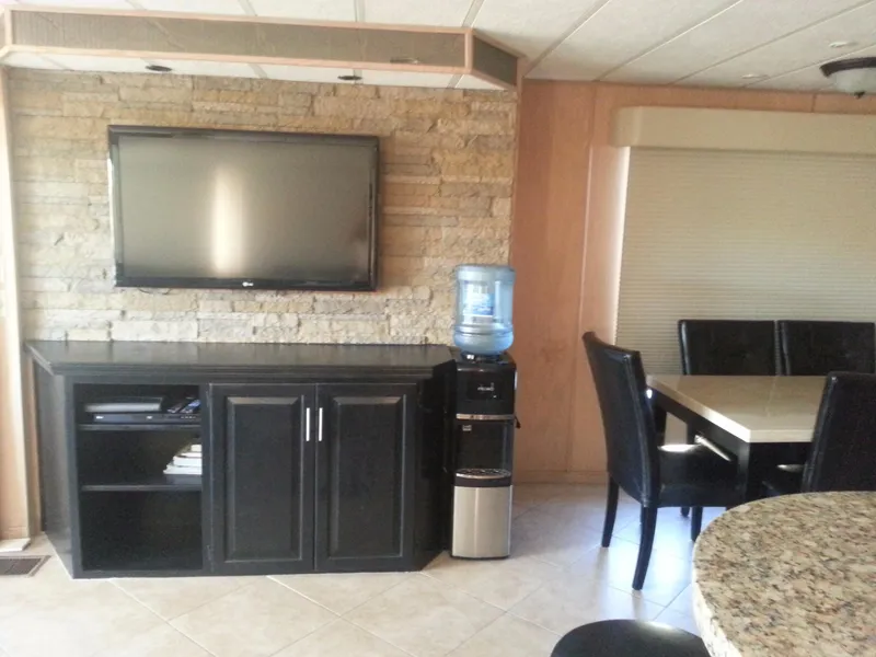 Slide: The Image of Modern interior of Stardust Cruisers Desert Oasis Share 20, featuring TV, water cooler, and dining area. - 7