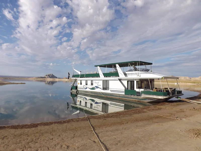 Slide: The Image of Houseboat "Desert Oasis Share 20" by Stardust Cruisers, 2001, on tranquil lake with cloudy sky. - 8