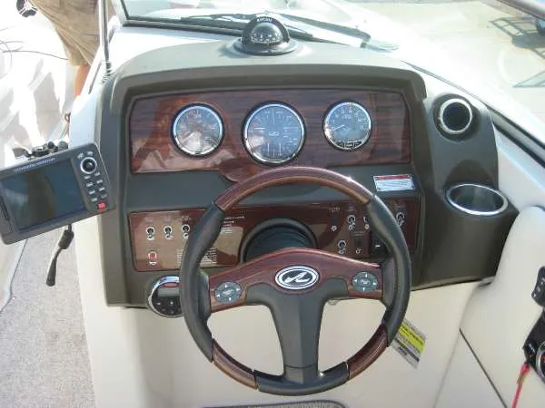 Slide: The Image of Dashboard of a 2008 Sea Ray 260 Sundeck boat with wood paneling. - 16