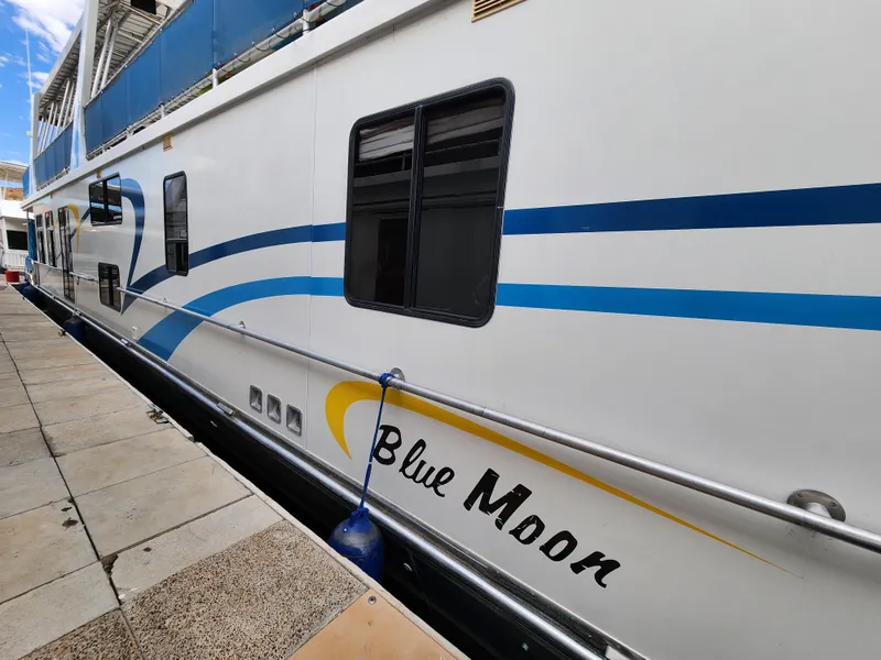 Slide: The Image of 2008 Sumerset Blue Moon Share #12 houseboat docked with blue and yellow accents. - 12