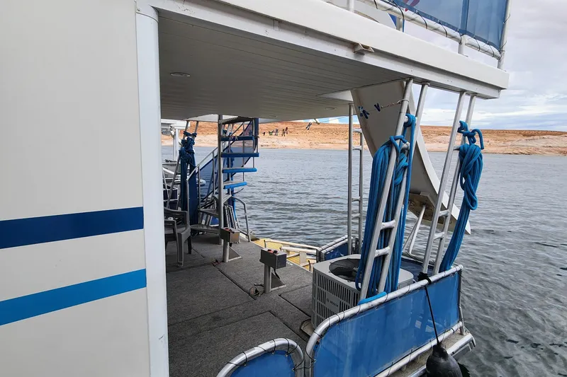 Slide: The Image of 2008 Sumerset Blue Moon Share #12 houseboat on a serene lake with blue accents. - 13