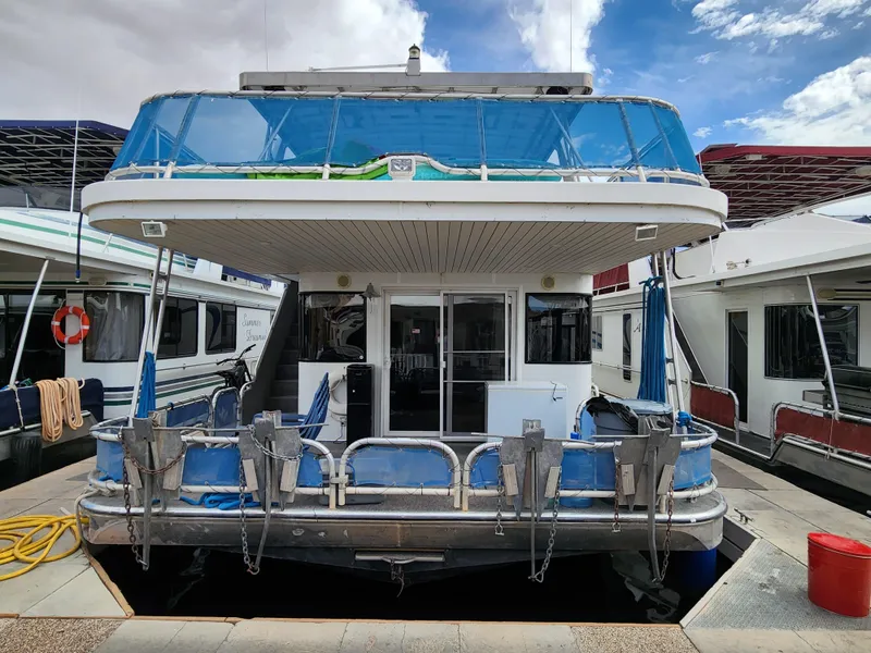 Slide: The Image of 2008 Sumerset Blue Moon Share #12 houseboat docked at marina, featuring upper deck and mooring equipment. - 14
