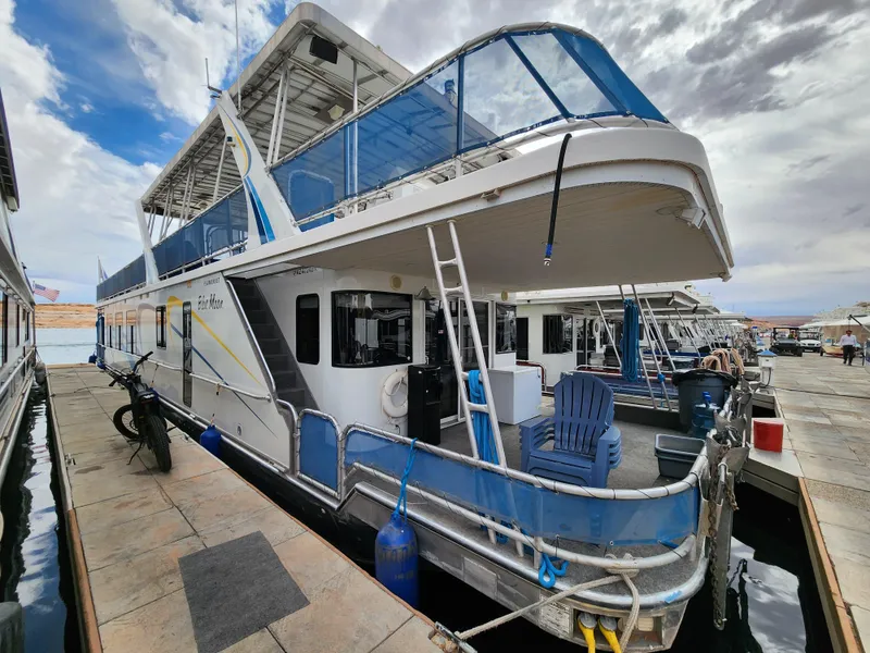 Slide: The Image of 2008 Sumerset Blue Moon Share #12 houseboat docked with blue accents and outdoor seating. - 15