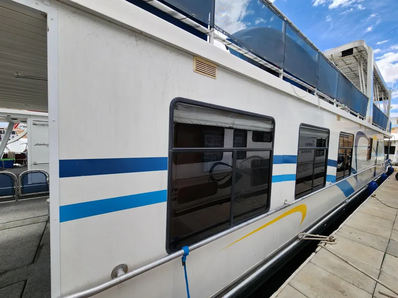 Slide: The Image of 2008 Sumerset Blue Moon Share #12 houseboat docked with blue and yellow accents. - 16