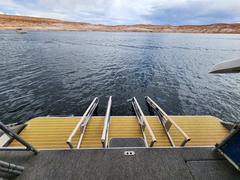 Slide: The Image of Rear view of 2008 Sumerset Blue Moon Share #12 houseboat with water and shoreline. - 18