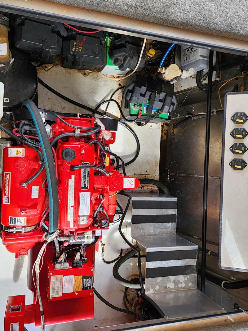 Slide: The Image of Engine room of 2008 Sumerset Blue Moon Share #12 with red machinery and control panel. - 23