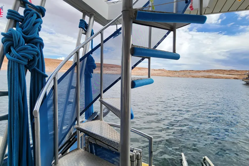 Slide: The Image of Spiral staircase on 2008 Sumerset Blue Moon Share #12 houseboat, overlooking serene lake and desert landscape. - 25