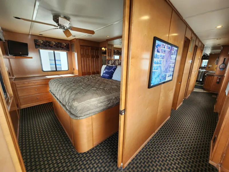 Slide: The Image of Interior of 2008 Sumerset Blue Moon Share #12 houseboat bedroom with wood paneling and ceiling fan. - 30