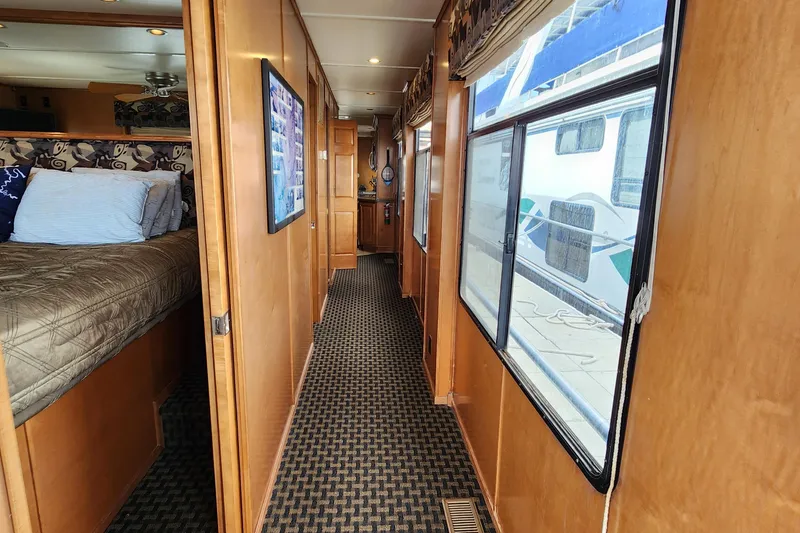 Slide: The Image of Interior hallway of 2008 Sumerset Blue Moon Share #12 houseboat, featuring wood paneling and carpet. - 32
