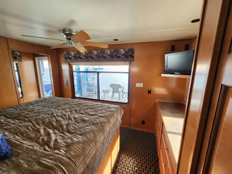 Slide: The Image of Interior of 2008 Sumerset Blue Moon Share #12 houseboat bedroom with bed, window, and TV. - 36