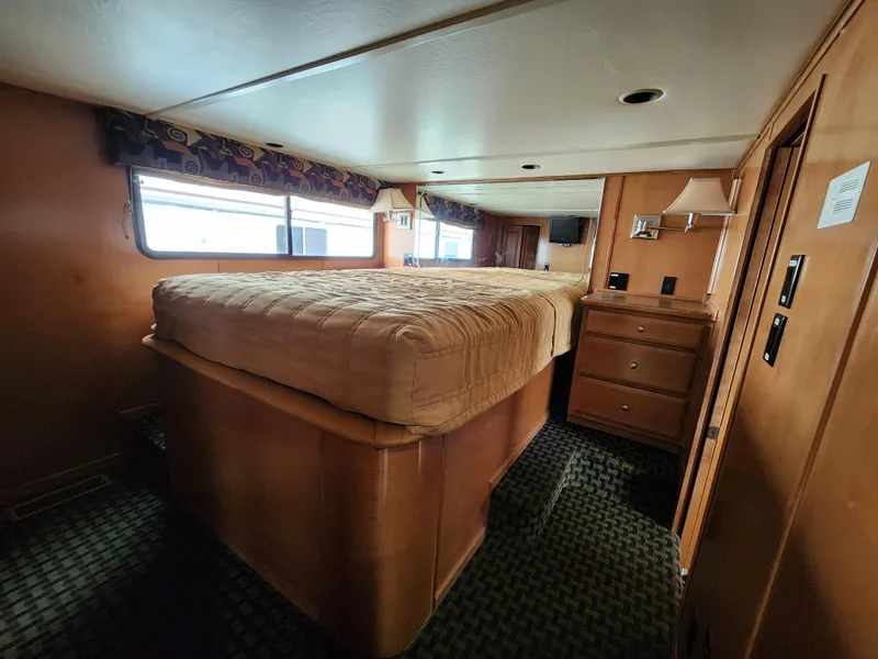 Slide: The Image of Interior of 2008 Sumerset Blue Moon Share #12 houseboat bedroom with bed and wooden furnishings. - 45