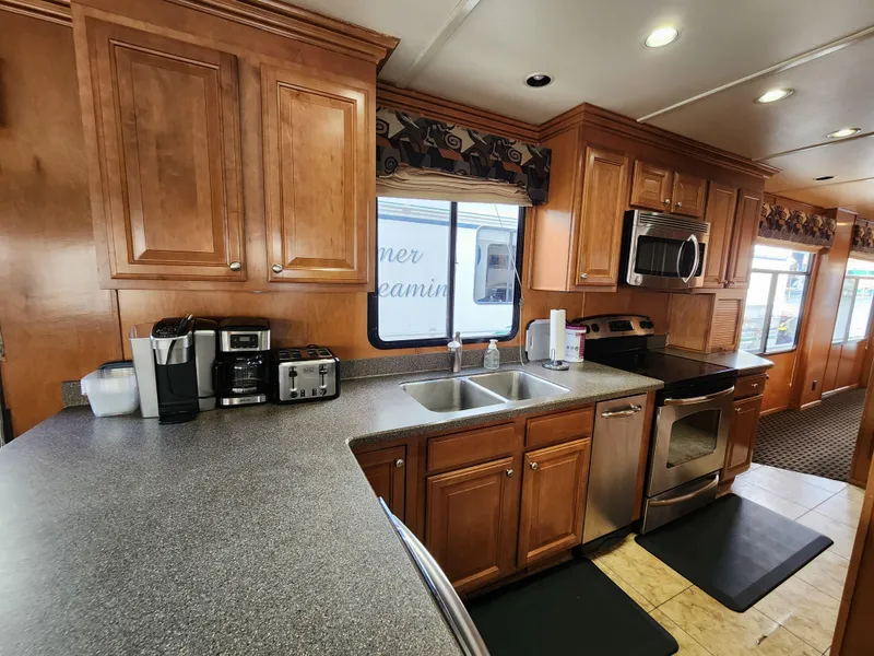 Slide: The Image of Modern kitchen in 2008 Sumerset Blue Moon Share #12 houseboat with wooden cabinets and stainless appliances. - 47