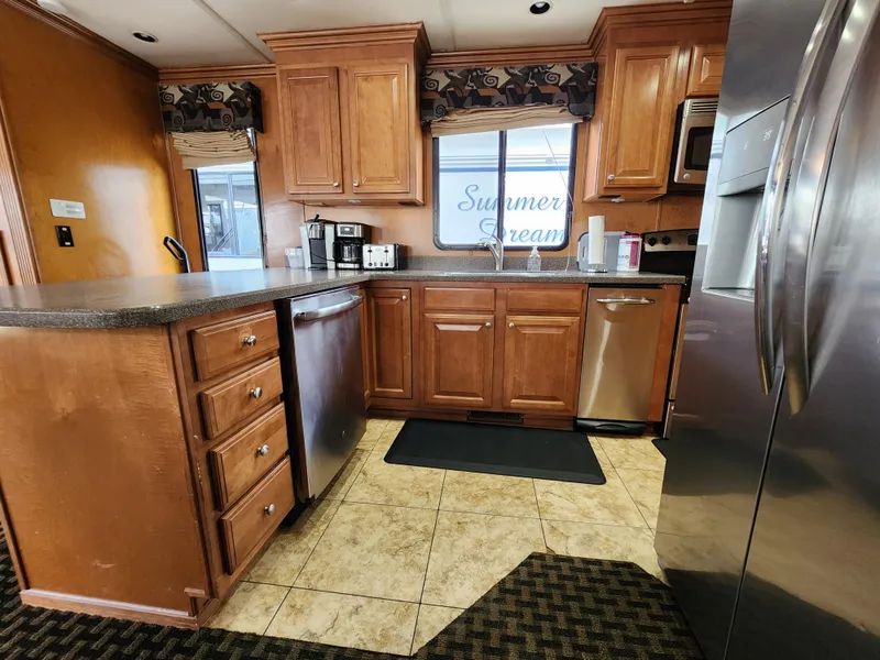Slide: The Image of Modern kitchen in 2008 Sumerset Blue Moon Share #12 houseboat with wooden cabinets and stainless steel appliances. - 48