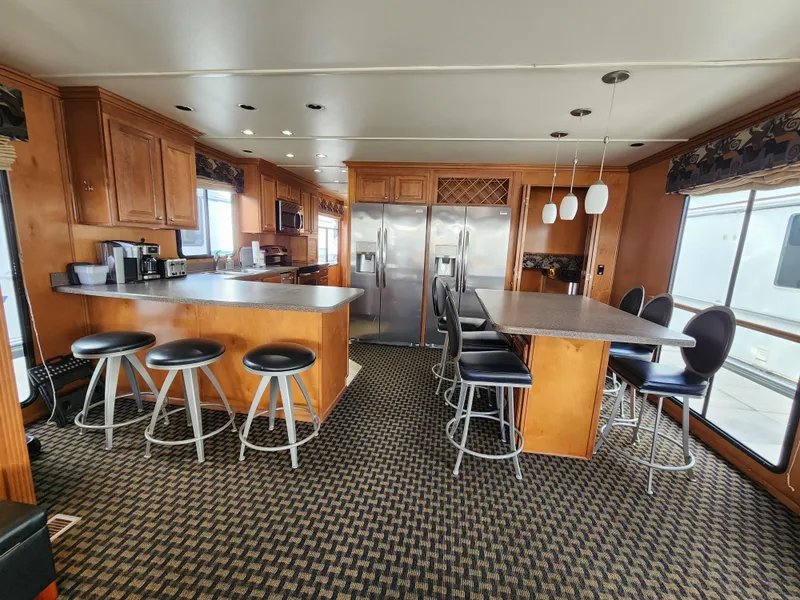 Slide: The Image of Spacious kitchen in 2008 Sumerset Blue Moon Share #12 houseboat with modern appliances and seating. - 49