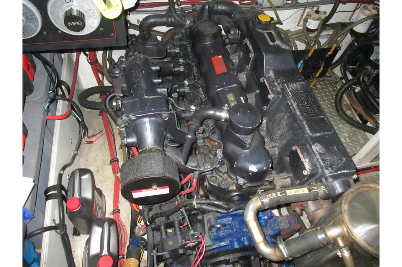 Slide: The Image of Engine room of 1988 Bayliner 3888 Motoryacht, showcasing detailed mechanical components. - 28