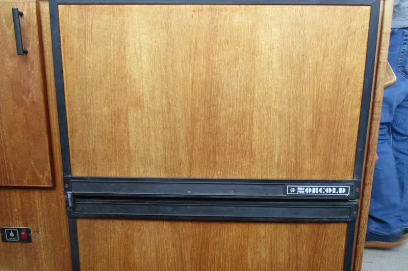 Slide: The Image of Wood-paneled Norcold refrigerator on 1988 Bayliner 3888 Motoryacht interior. - 8