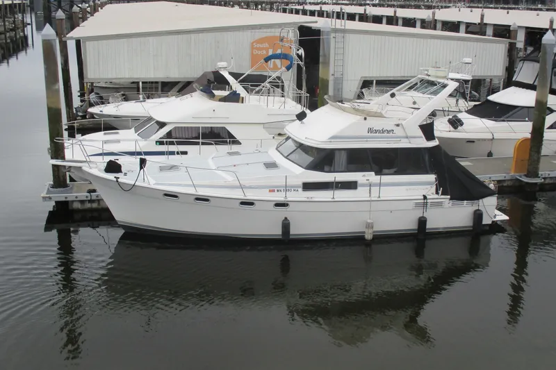 Slide: The Image of 1988 Bayliner 3888 Motoryacht docked at marina, side view. - 22