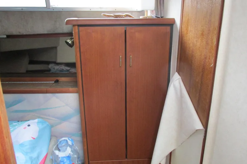Slide: The Image of 1988 Bayliner 3888 Motoryacht interior with wooden cabinet and nautical decor. - 10