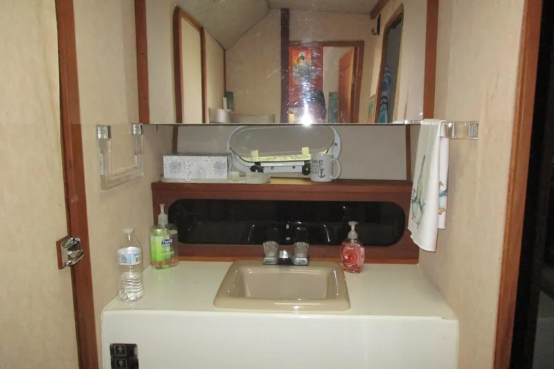 Slide: The Image of Bathroom vanity in 1988 Bayliner 3888 Motoryacht with mirror and sink. - 11