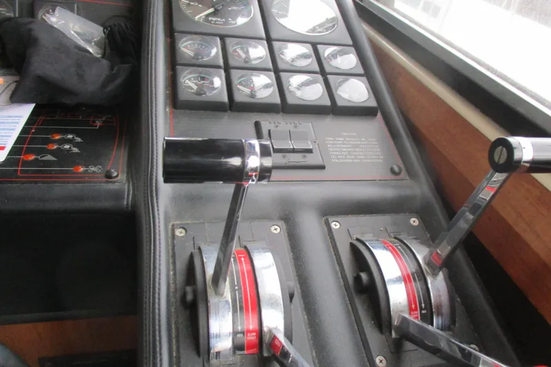 Slide: The Image of Control panel of a 1988 Bayliner 3888 Motoryacht with throttle levers and gauges. - 26