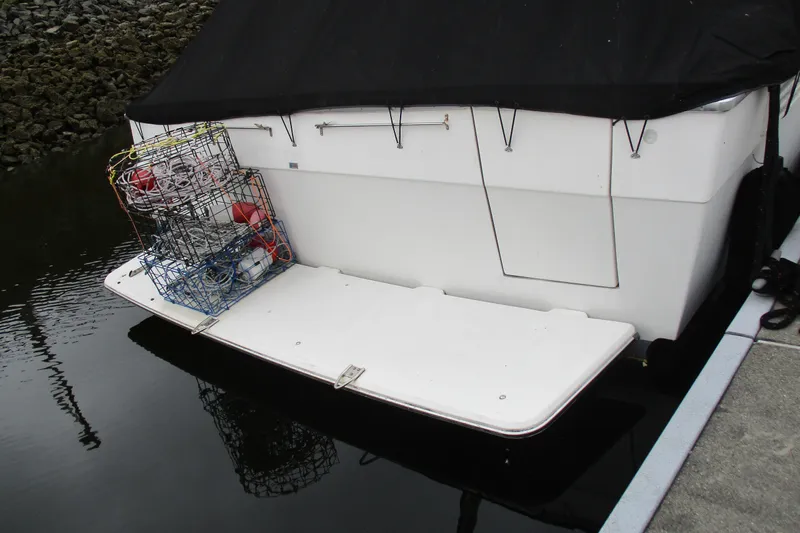 Slide: The Image of 1988 Bayliner 3888 Motoryacht stern with crab pots and buoys on swim platform. - 4