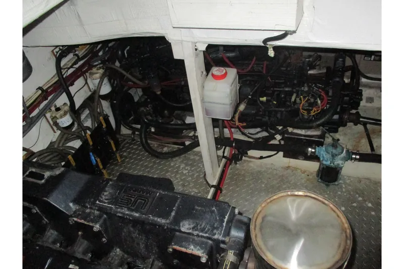 Slide: The Image of Engine room of 1988 Bayliner 3888 Motoryacht, showcasing mechanical components and wiring. - 29