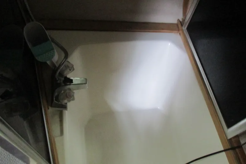 Slide: The Image of Interior of 1988 Bayliner 3888 Motoryacht showing a compact bathroom sink area. - 13
