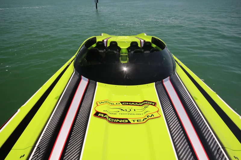 Slide: The Image of 2025 MTI Marine Technology Inc 48 Pleasure boat on water, vibrant green and black design. - 5