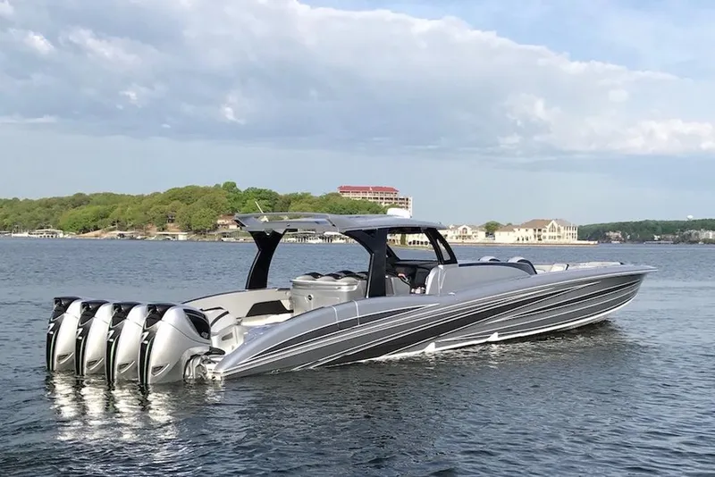 Slide: The Image of 2025 MTI V Marine Technology Inc V 57 boat with five outboard engines on a lake. - 1