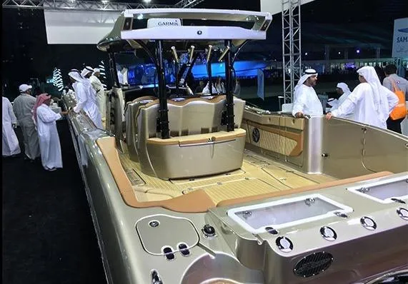 Slide: The Image of 2025 MTI V Marine Technology Inc V 57 luxury boat on display at an event. - 14