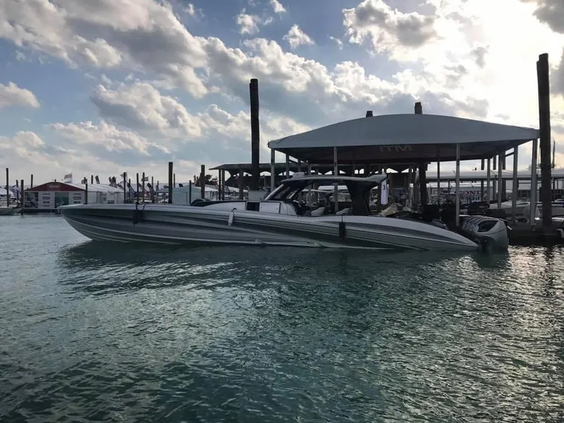 Slide: The Image of 2025 MTI V Marine Technology Inc V 57 boat docked at marina under cloudy sky. - 15