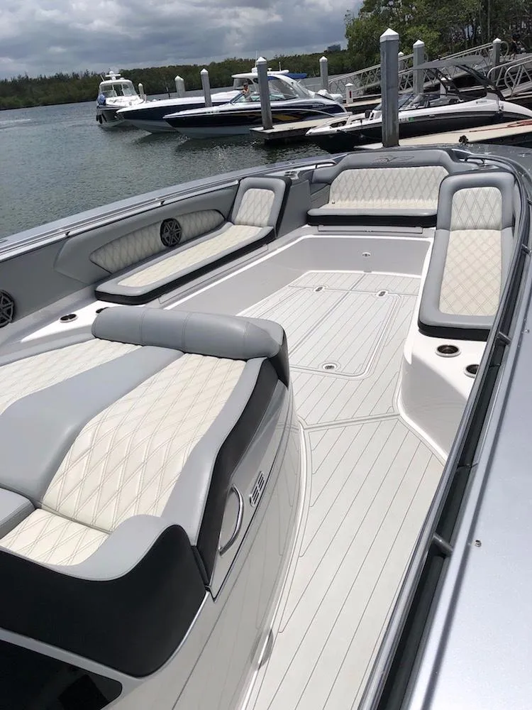 Slide: The Image of 2025 MTI V Marine Technology Inc V 57 luxury boat with spacious seating at a dock. - 19