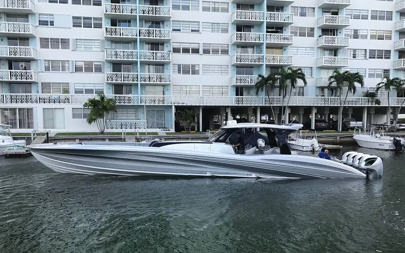 Slide: The Image of 2025 MTI V Marine Technology Inc V 57 boat docked near waterfront apartments. - 2