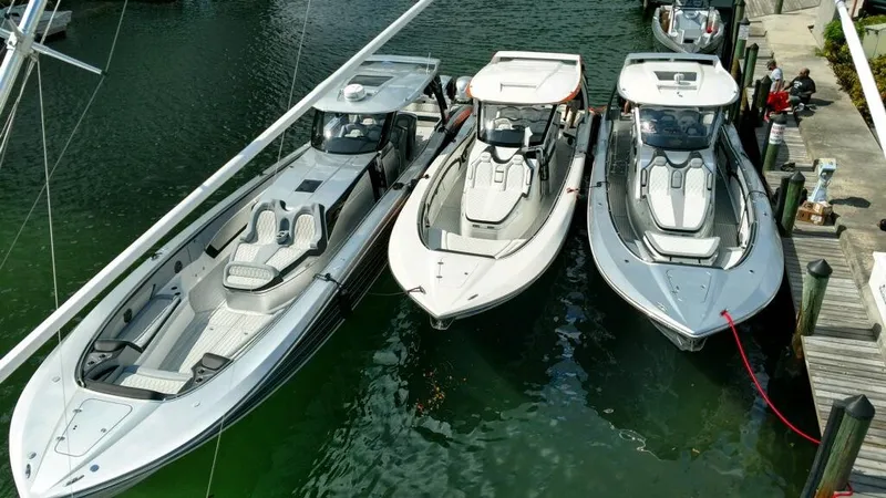 Slide: The Image of Three 2025 MTI V Marine Technology Inc V 57 boats docked side by side in a marina. - 4