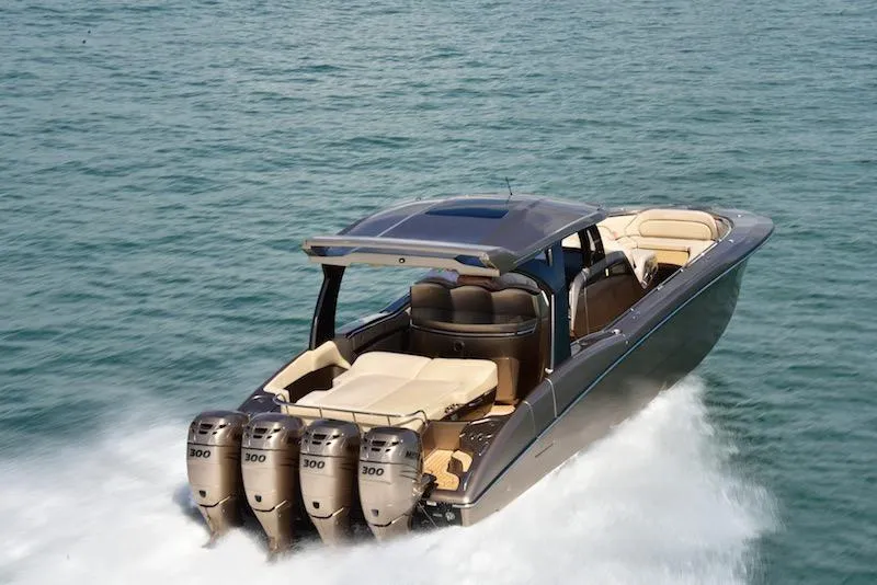 Slide: The Image of 2025 MTI V Marine Technology Inc V 42 boat cruising on water with four outboard engines. - 10