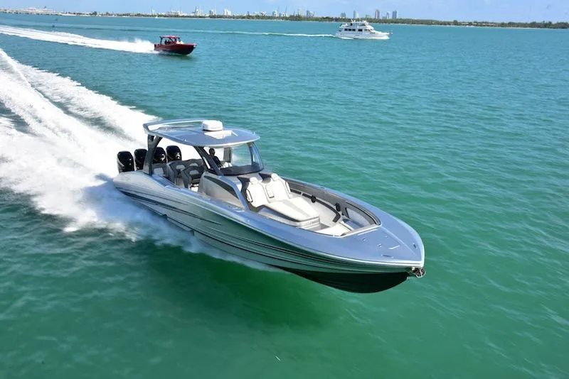 Slide: The Image of 2025 MTI V Marine Technology Inc V 42 speedboat cruising on open water. - 2